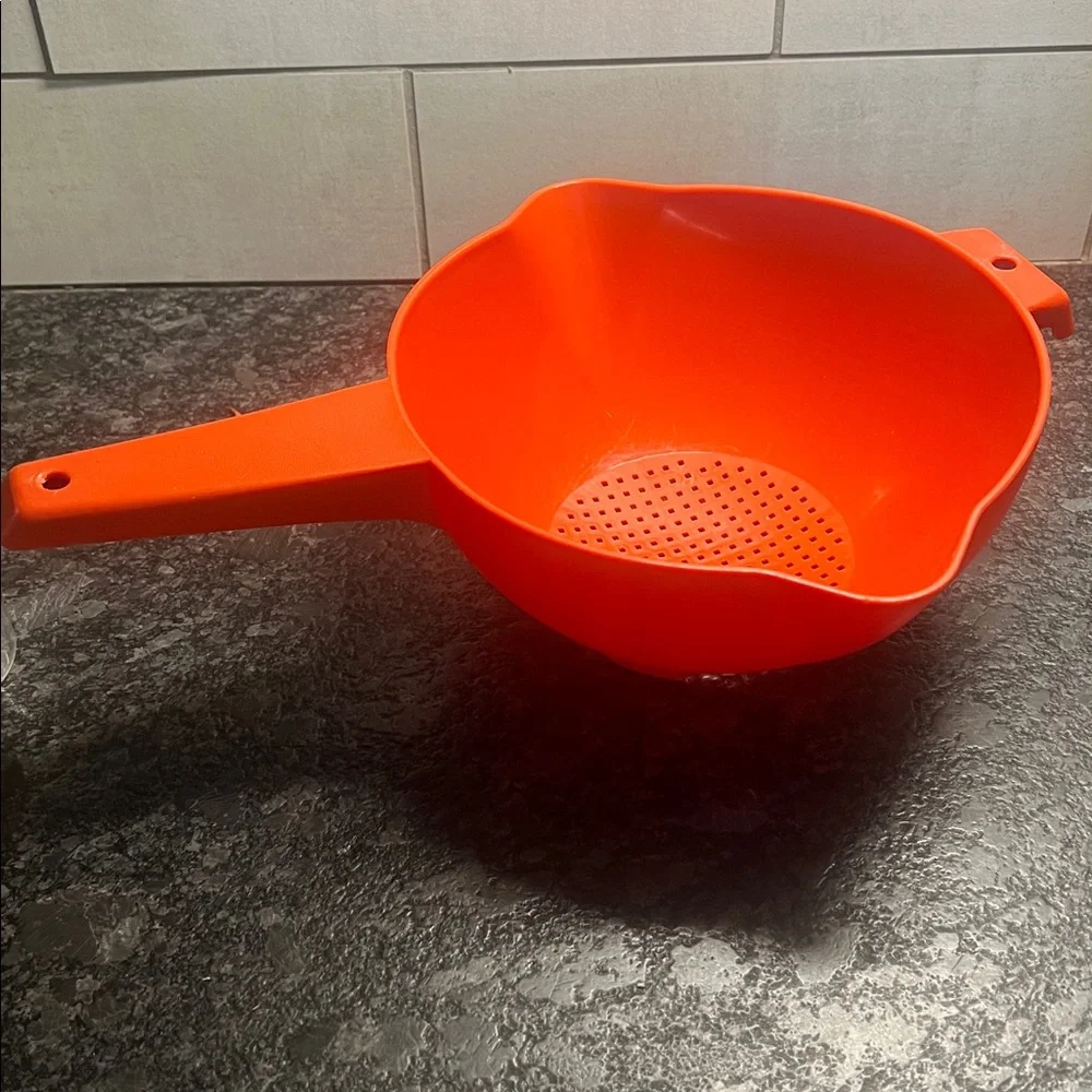 Vintage 8” Red Strainer with Handle by Tupperware. Exc condition. Looks new